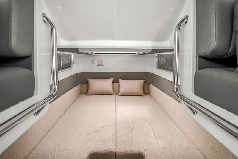 Slide: The Image of 2021 Axopar 37 XC Cross Cabin interior with cozy sleeping area and cushions. - 37