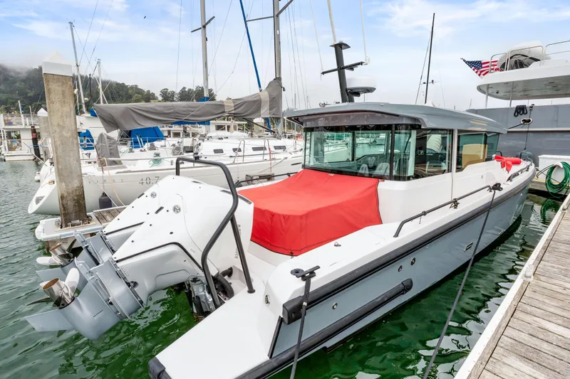 Slide: The Image of 2021 Axopar 37 XC Cross Cabin docked at marina with red cover. - 42