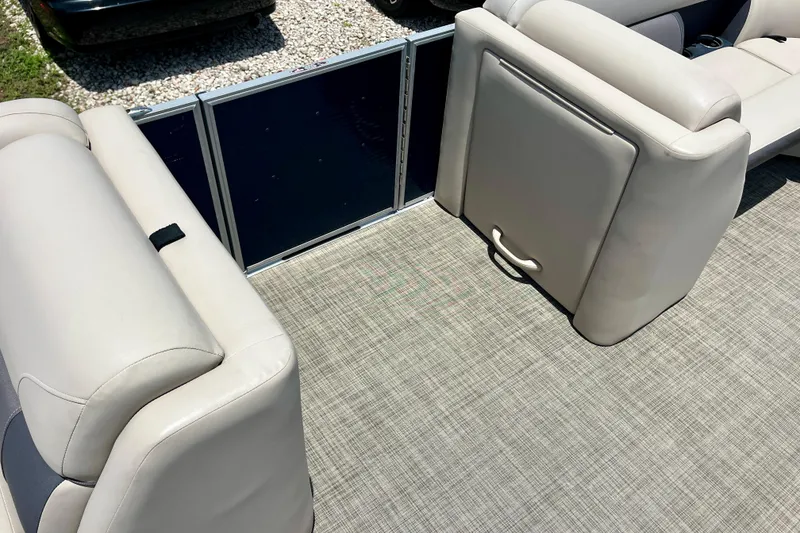 Slide: The Image of 2023 Harris Cruiser 230 interior with beige seating and textured flooring. - 10