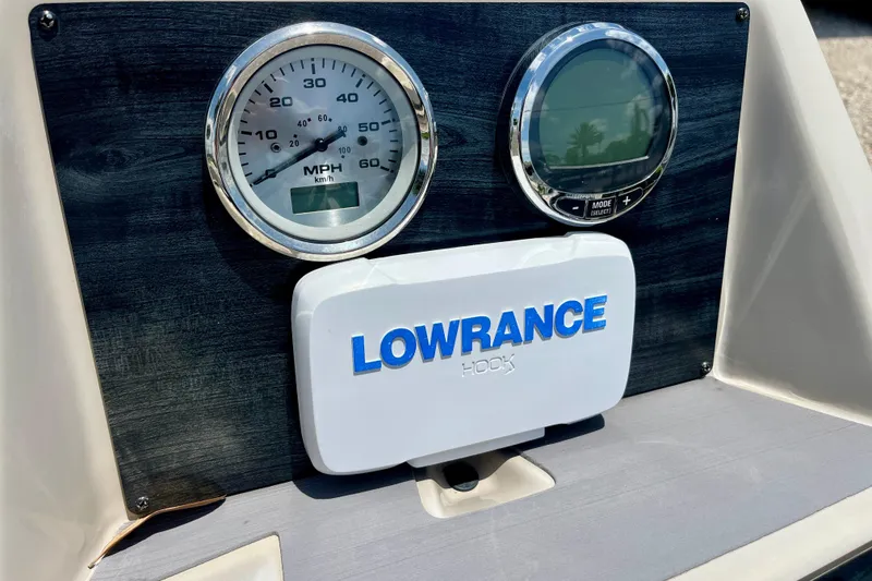 Slide: The Image of Dashboard of 2023 Harris Cruiser 230 with Lowrance Hook display and speedometer. - 14