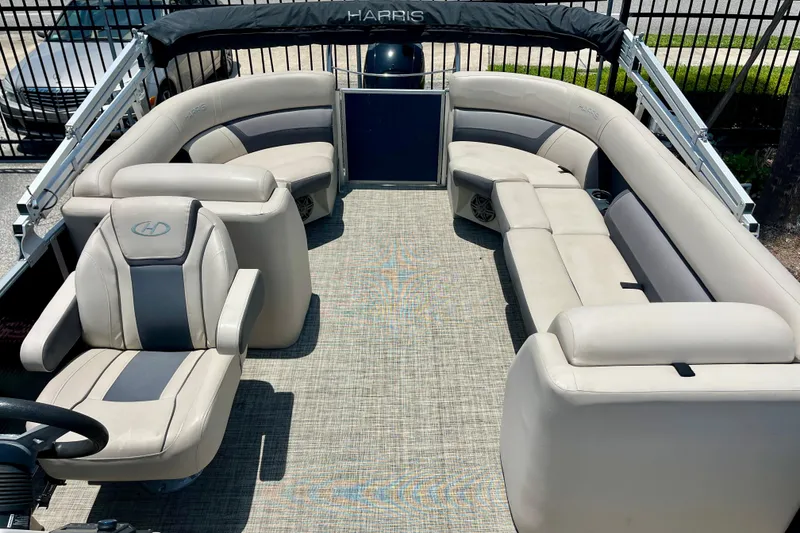 Slide: The Image of 2023 Harris Cruiser 230 pontoon boat with spacious seating and modern design. - 8
