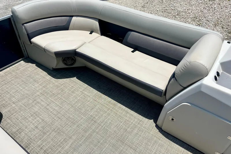 Slide: The Image of 2023 Harris Cruiser 230 boat interior with cushioned seating and carpeted floor. - 9