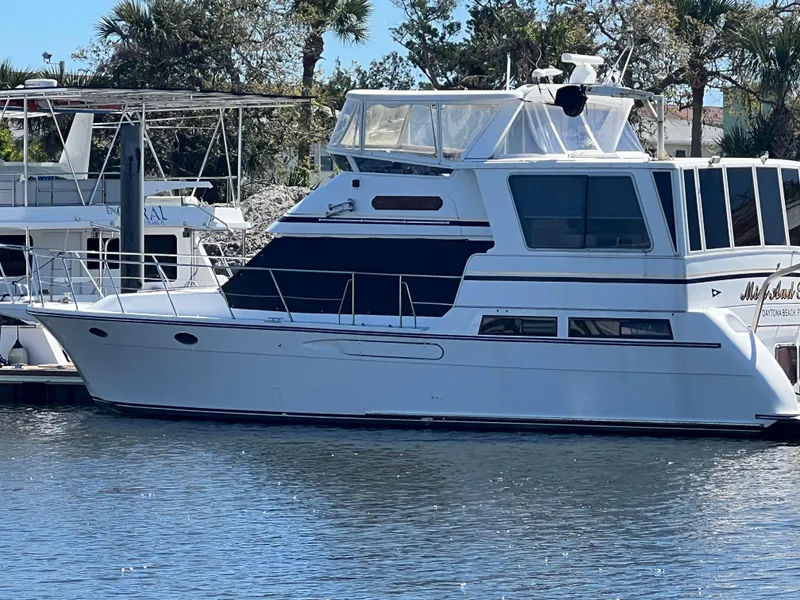 Slide: The Image of 1998 Hyatt 51 Aft Cabin Motor Yacht docked in a marina. - 2