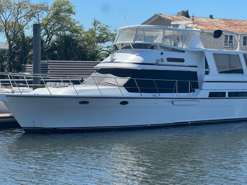 Slide: The Image of 1998 Hyatt 51 Aft Cabin Motor Yacht docked in a marina. - 3