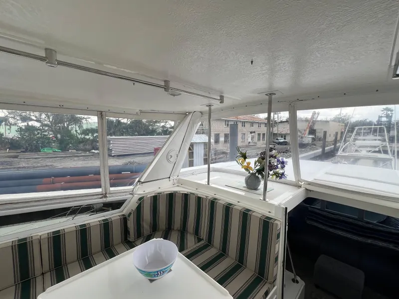 Slide: The Image of 1998 Hyatt 51 Aft Cabin Motor Yacht interior with striped seating and table. - 36