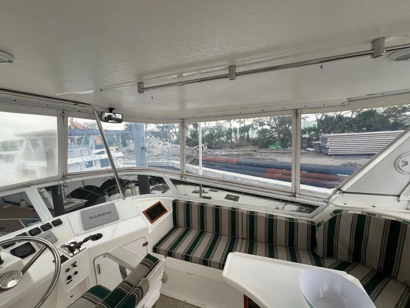 Slide: The Image of 1998 Hyatt 51 Aft Cabin Motor Yacht interior with striped seating and navigation equipment. - 37