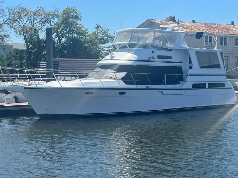 Slide: The Image of 1998 Hyatt 51 Aft Cabin Motor Yacht docked in sunny marina. - 4