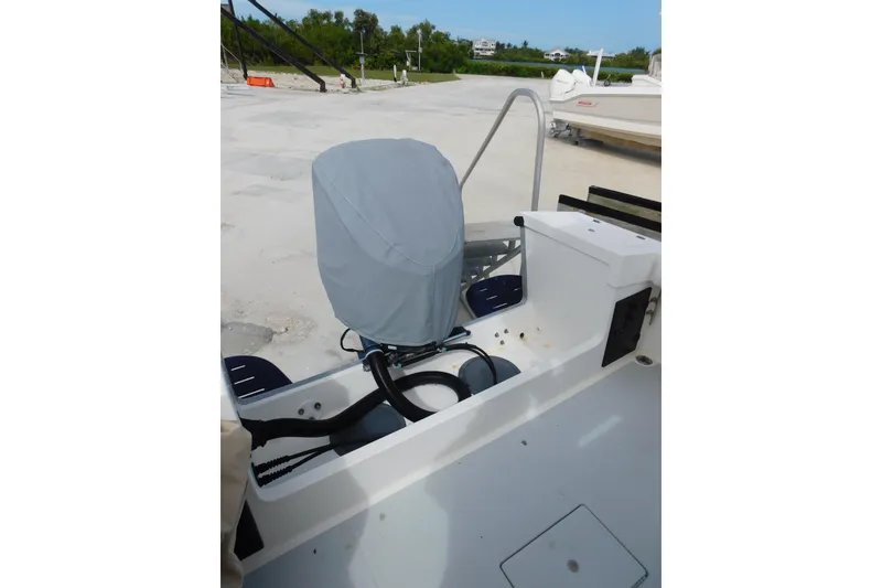 Slide: The Image of 1996 Regulator 23 Center Console boat with covered outboard motor. - 10