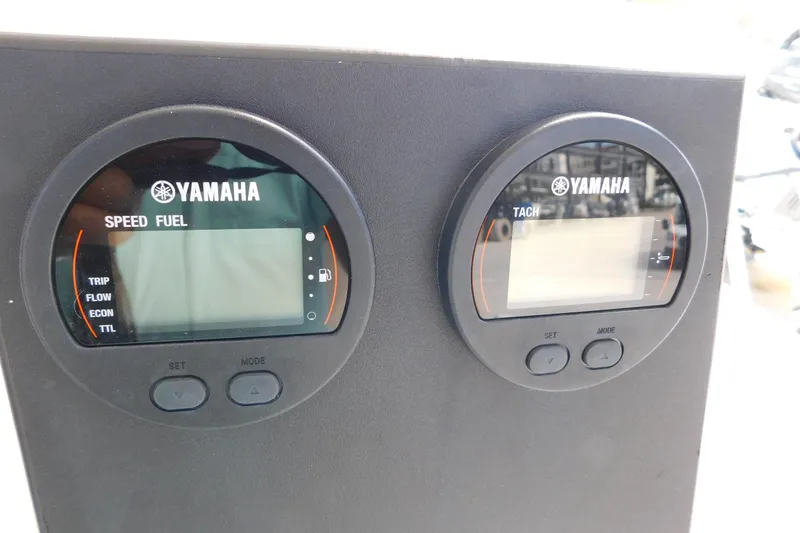 Slide: The Image of Yamaha speed and tach gauges on a 1996 Regulator 23 Center Console boat. - 18