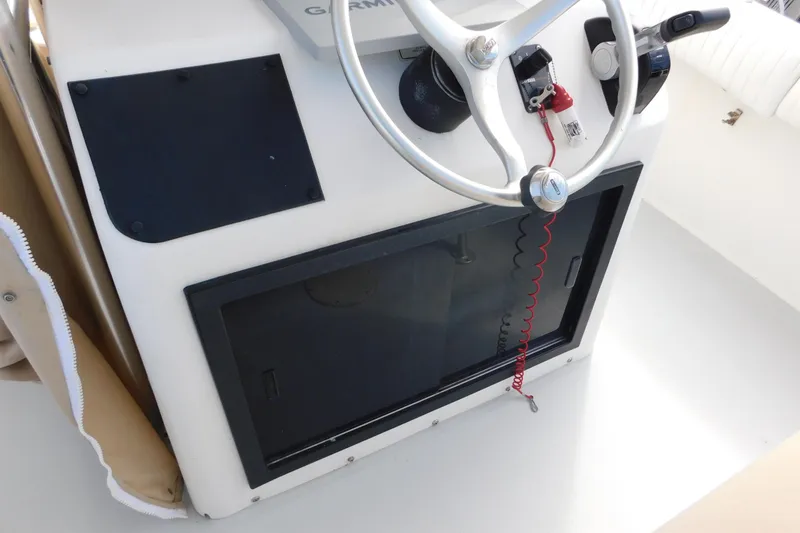 Slide: The Image of 1996 Regulator 23 Center Console helm with steering wheel and control panel. - 19