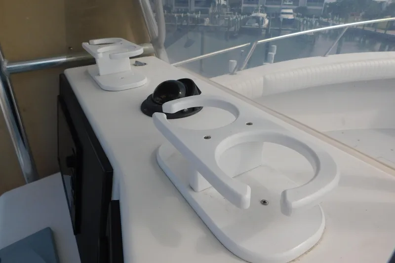 Slide: The Image of Cup holders and compass on a 1996 Regulator 23 Center Console boat dashboard. - 20