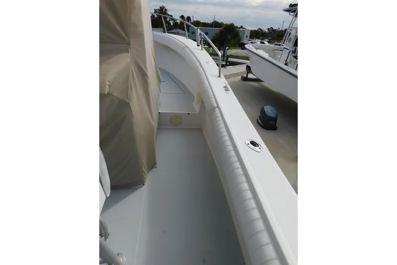 Slide: The Image of 1996 Regulator 23 Center Console boat deck with covered seating and railing. - 27