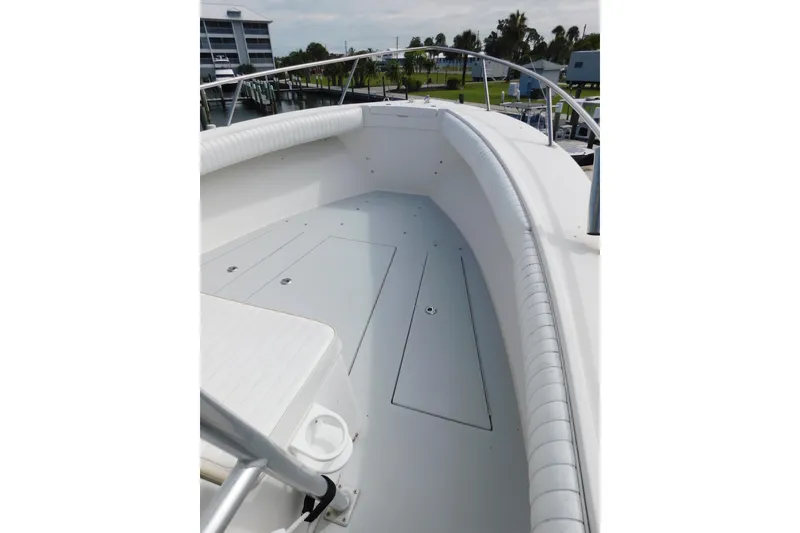 Slide: The Image of 1996 Regulator 23 Center Console boat deck with cushioned seating and storage compartments. - 28