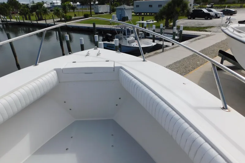 Slide: The Image of 1996 Regulator 23 Center Console boat docked at marina, featuring spacious bow seating. - 30