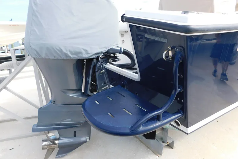 Slide: The Image of 1996 Regulator 23 Center Console boat with covered outboard motor and swim platform. - 9