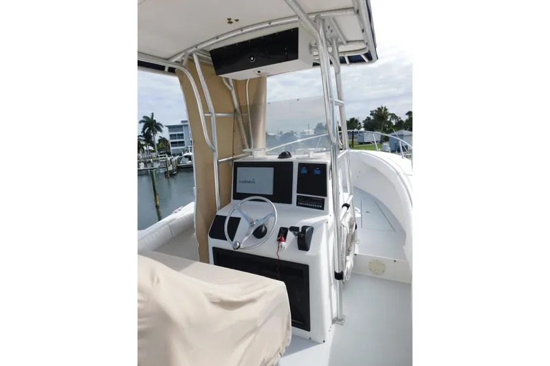 Slide: The Image of 1996 Regulator 23 Center Console boat interior with Garmin navigation system and steering wheel. - 13