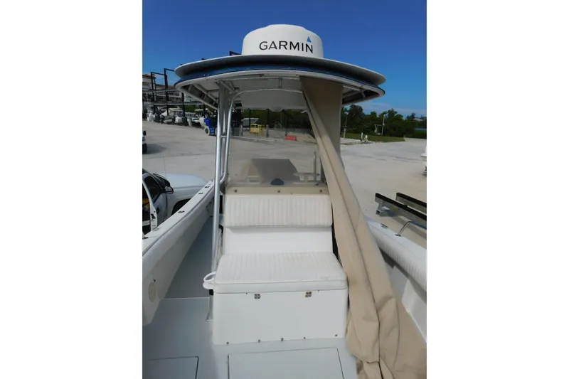 Slide: The Image of 1996 Regulator 23 Center Console boat with Garmin equipment, docked outdoors. - 21