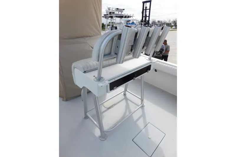 Slide: The Image of 1996 Regulator 23 Center Console boat with rod holders and cushioned seating. - 22
