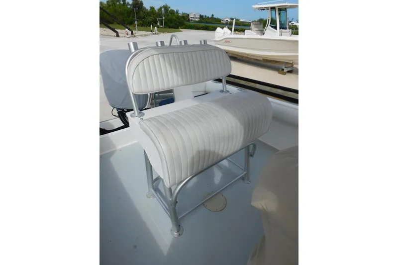 Slide: The Image of 1996 Regulator 23 Center Console boat with white cushioned seating. - 23