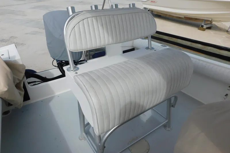 Slide: The Image of 1996 Regulator 23 Center Console boat interior with cushioned seating and rod holders. - 24