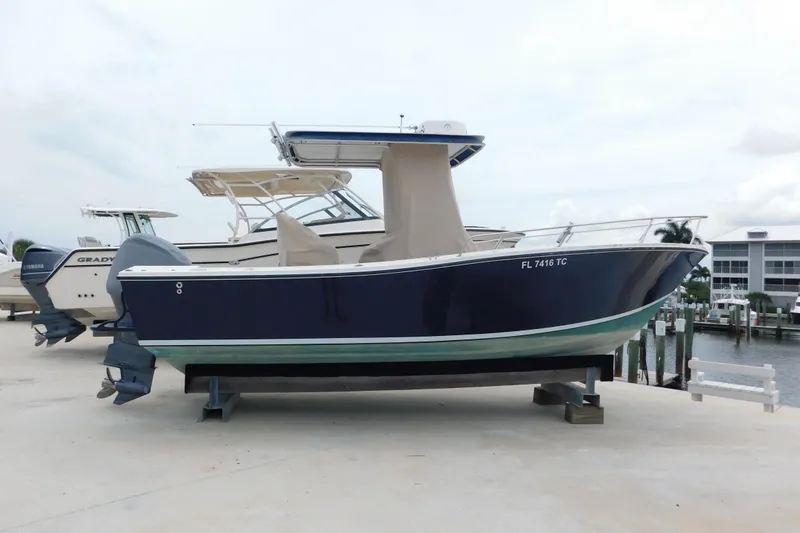 Slide: The Image of 1996 Regulator 23 Center Console boat on display at a marina. - 3