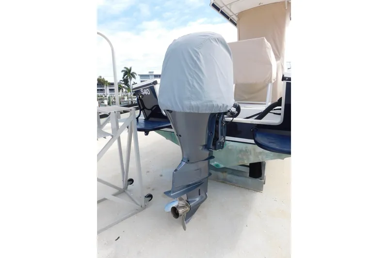 Slide: The Image of 1996 Regulator 23 Center Console boat with covered outboard motor, docked outdoors. - 6
