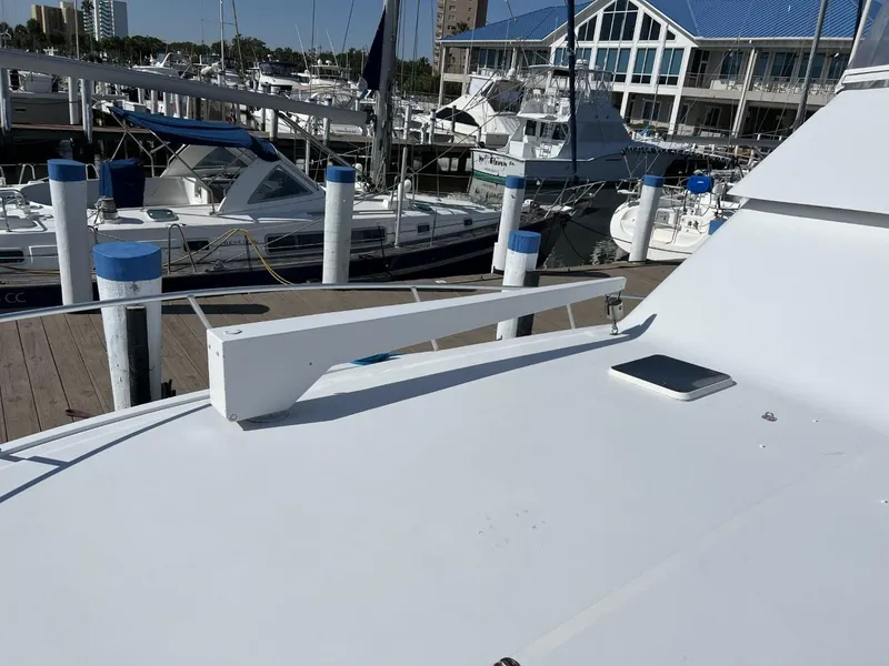 Slide: The Image of 1991 Viking Convertible yacht docked at marina with other boats in background. - 15