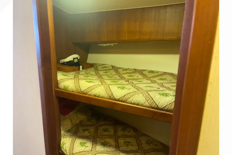 Slide: The Image of Cozy cabin bunk beds in 1991 Viking Convertible boat interior. - 51