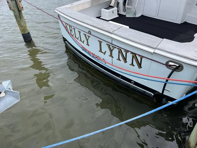 Slide: The Image of 1991 Viking Convertible boat named "Kelly Lynn" docked in water. - 8
