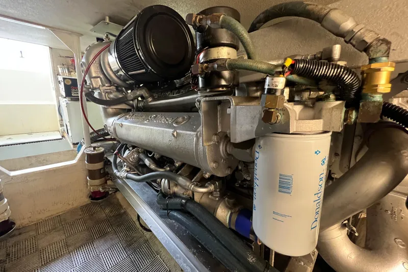 Slide: The Image of Engine room of a 1991 Viking Convertible boat, showcasing detailed machinery and components. - 84