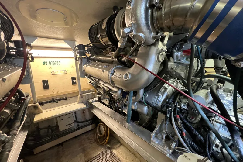 Slide: The Image of Engine room of a 1991 Viking Convertible boat, showcasing detailed machinery and components. - 85