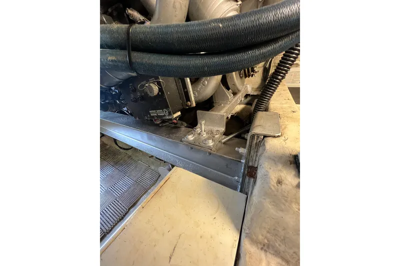 Slide: The Image of Engine compartment of a 1991 Viking Convertible boat with visible hoses and components. - 88