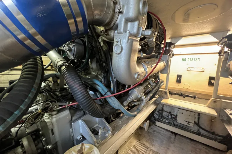 Slide: The Image of Engine room of a 1991 Viking Convertible boat, showcasing complex machinery and components. - 92
