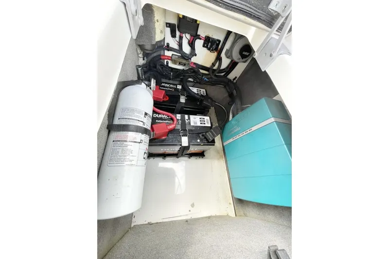 Slide: The Image of 2023 Sea Ray 290 Amberjack engine compartment with batteries and fire extinguisher. - 16