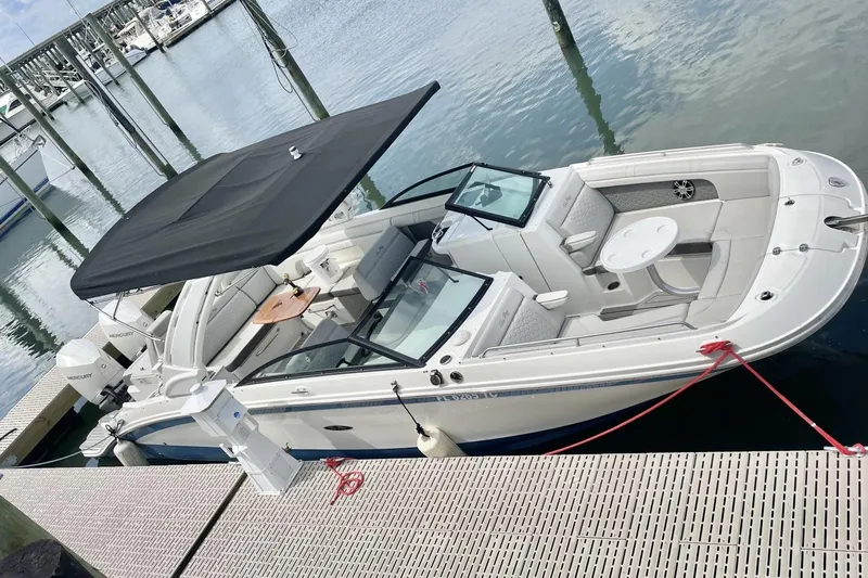 Slide: The Image of 2023 Sea Ray 290 Amberjack boat docked with canopy and seating area. - 3
