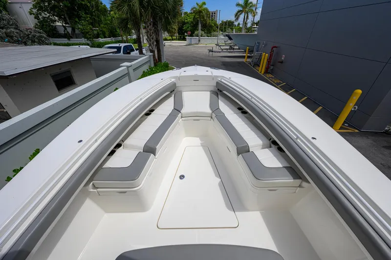Slide: The Image of 2023 Regulator 28 boat with spacious seating and sleek design in a marina setting. - 14