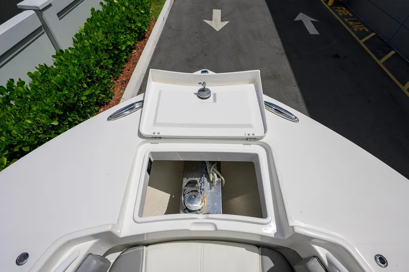 Slide: The Image of 2023 Regulator 28 boat anchor compartment, open lid, dockside view. - 18