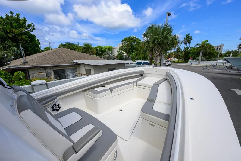 Slide: The Image of 2023 Regulator 28 boat with spacious seating, set against a tropical backdrop. - 19