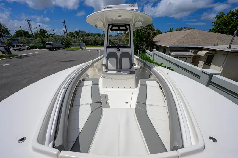 Slide: The Image of 2023 Regulator 28 boat with spacious seating and modern design under a clear sky. - 21