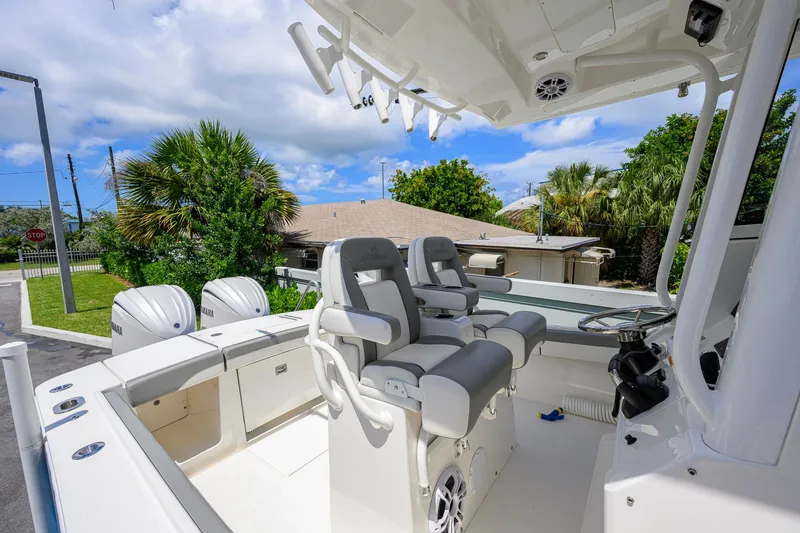 Slide: The Image of 2023 Regulator 28 boat interior with dual Yamaha engines and luxury seating. - 26