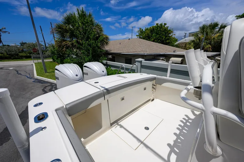 Slide: The Image of 2023 Regulator 28 boat deck with Yamaha engines, sunny day, residential background. - 29
