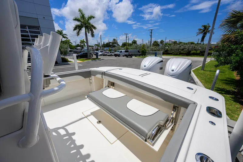 Slide: The Image of 2023 Regulator 28 boat with seating and twin Yamaha engines, parked outdoors. - 33