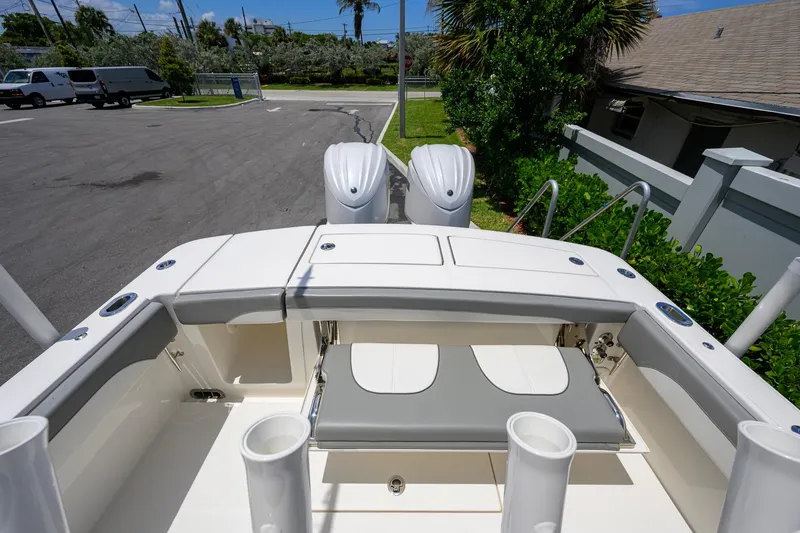 Slide: The Image of 2023 Regulator 28 boat with dual engines, docked in a sunny marina setting. - 35