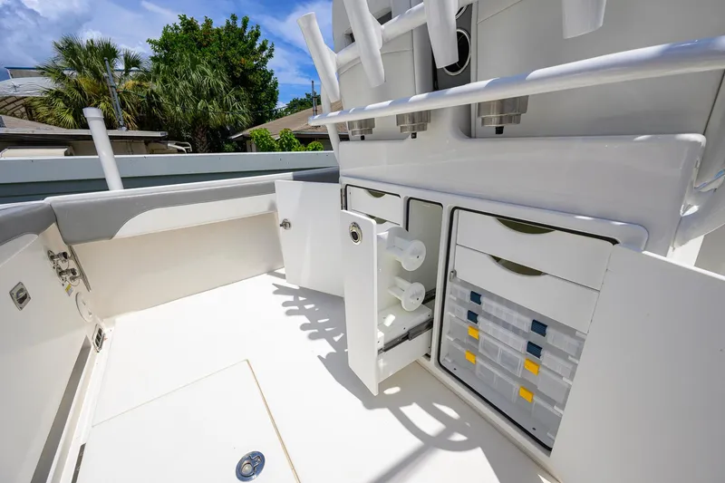 Slide: The Image of 2023 Regulator 28 boat interior with storage compartments and rod holders. - 38