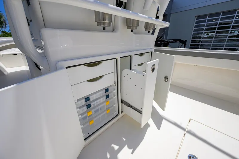 Slide: The Image of 2023 Regulator 28 boat storage compartments with organized tackle boxes and drawers. - 40