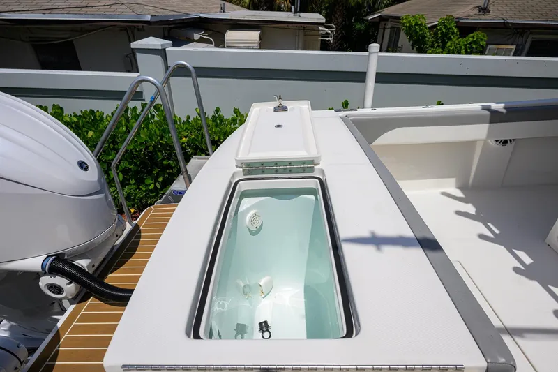 Slide: The Image of 2023 Regulator 28 boat deck with livewell and Yamaha engine. - 44