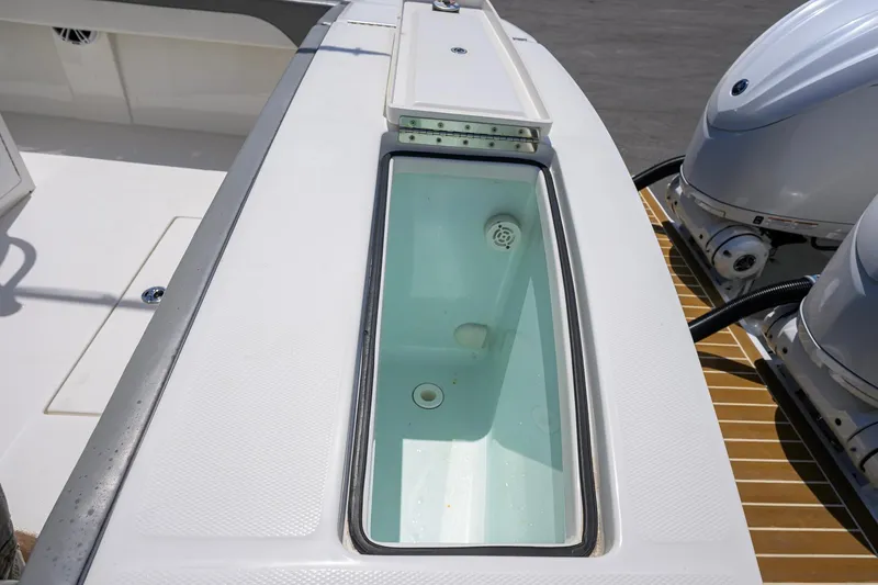 Slide: The Image of 2023 Regulator 28 boat with livewell and dual outboard engines. - 45