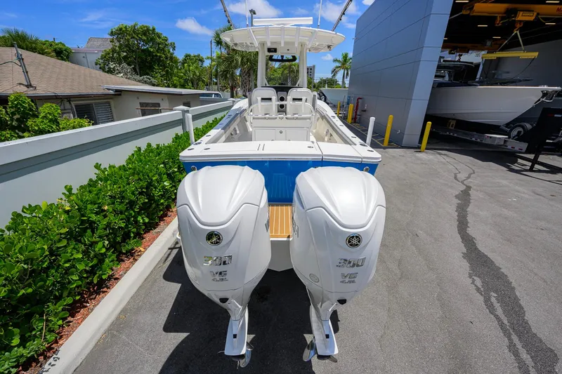Slide: The Image of 2023 Regulator 28 boat with dual Yamaha 300 V6 engines, parked outdoors. - 47