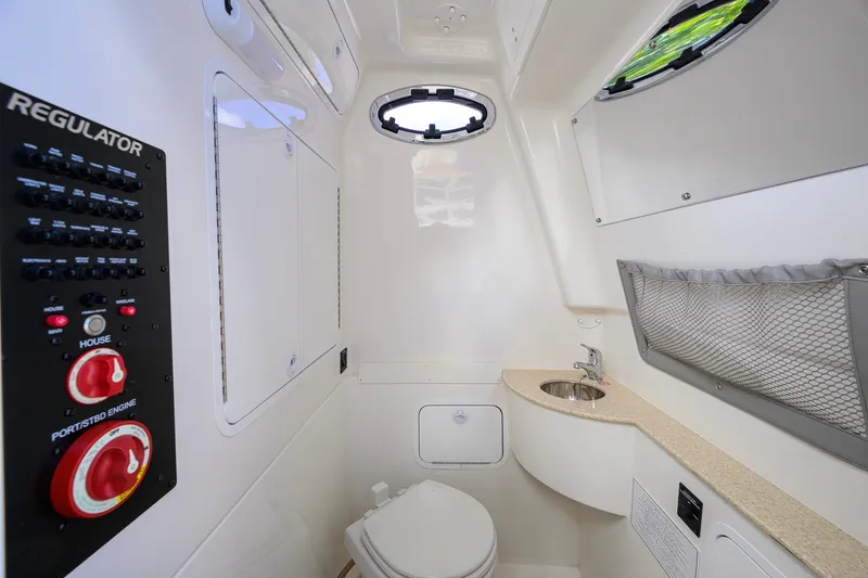 Slide: The Image of 2023 Regulator 28 boat interior with control panel, sink, and toilet. - 50