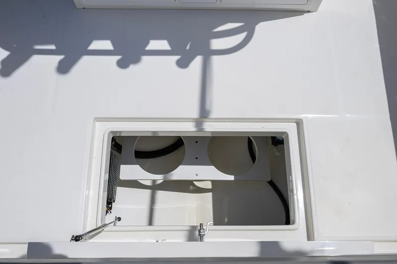 Slide: The Image of Open storage compartment on 2023 Regulator 28 boat deck. - 52